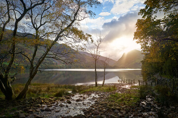 Views of Fleetwith Pike at sunrise across Buttermere in Autumn in the Lake District, UK.