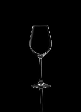 Empty glass for white wine isolated on black background