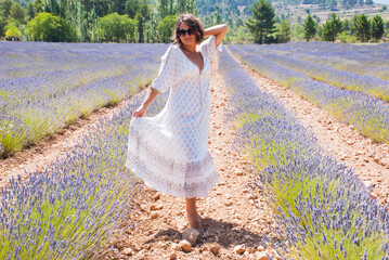 Woman in white dress in lavender field. Beauty of nature.
