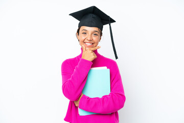 Young student hispanic woman holding a books isolated on white background happy and smiling