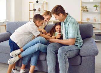 Kids and parents having fun. Happy funny family playing together. Cheerful mother, father and...
