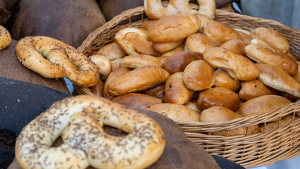 Home-baked meat pies in a wicker basket next to some pretzels. Traditional Latvian dishes. Rural market.