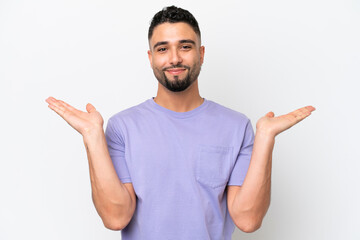 Young Arab handsome man isolated on white background having doubts