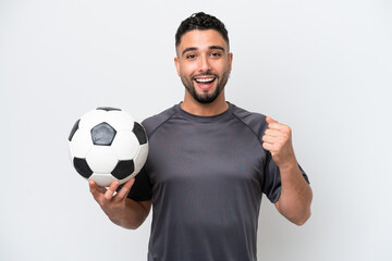 Arab young football player man isolated on white background celebrating a victory in winner position
