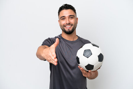 Arab young football player man isolated on white background shaking hands for closing a good deal