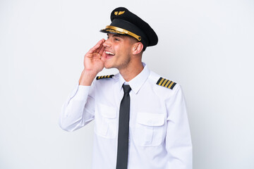 Airplane caucasian pilot isolated on white background shouting with mouth wide open to the lateral