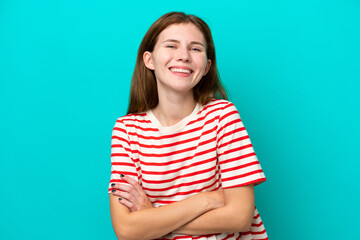 Young English woman isolated on blue background keeping the arms crossed in frontal position