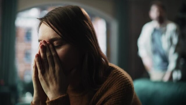 Portrait of Sad Crying Woman being Harrased and Bullied by Her Partner. Couple Arguing and Fighting Violently. Domestic Violence and Emotional Abuse. Rack Focus with Boyfriend Screaming in Background