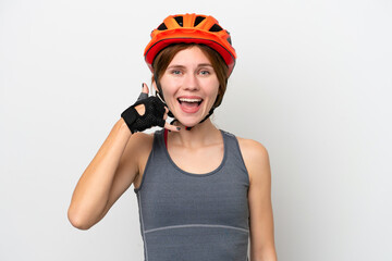 Young cyclist English woman isolated on white background making phone gesture. Call me back sign