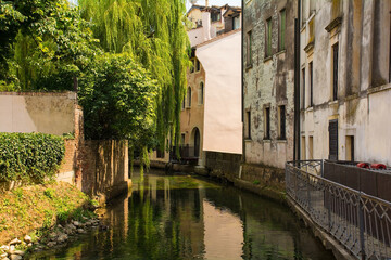 Fototapeta na wymiar The Roggia Siletto river as it flows through the historic centre of Treviso in Veneto, north east Italy 