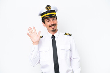 Airplane caucasian pilot isolated on white background saluting with hand with happy expression