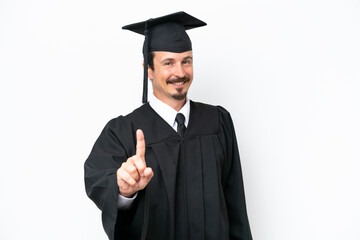 Young university graduate man isolated on white background showing and lifting a finger