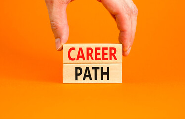 Career path symbol. Concept words Career path on wooden blocks on a beautiful orange table orange background. Businessman hand. Business Career path concept. Copy space.