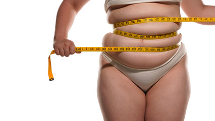 Overweight woman with tape is measuring fat on belly