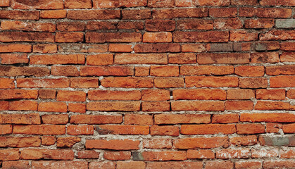 Red brick wall texture. Abstract brick wall background, wall of old, cracked bricks, with a weathered and faded surface.	
