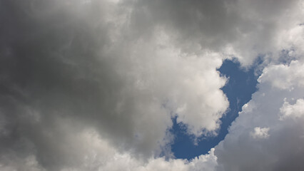 Rain clouds cover the blue sky.