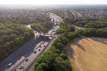 Waterworks roundabout in Walthamstow. A large roundabout with the A406 dual carriageway passing underneath in the morning sun surrounded by the forest