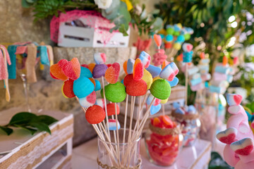 Colorful candy and gummy kabobs on a wedding party