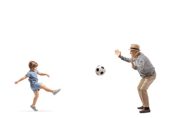 Full length profile shot of a little girl playing football with a senior man