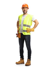 Full length portrait of a construction worker wearing a tool belt and smiling at camera