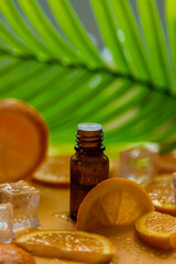 Essential oil of orange on a yellow background. Selective focus.