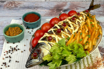 Fried mackerel fish with french fries, tomatoes and celery leaves, mustard and ketchup. - 520039519
