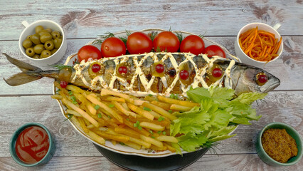 Fried mackerel fish with french fries, tomatoes and celery leaves, mustard and ketchup. - 520039520
