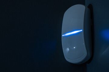 Modern motion sensor in action in a dark room.