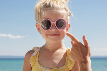 Mother applying sunscreen protection lotion on her daughter face