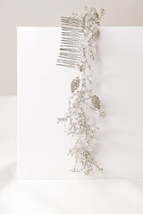 Bridal handmade hair jewelry comb made of silver alloy and crystal on white background.