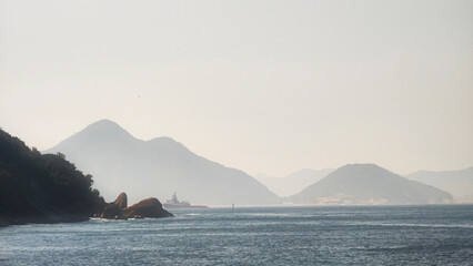 beach sea ocean sand wave boat freighter tugboat horizon landscape island hill mountain stone granite cliff sugarloaf red beach cable car