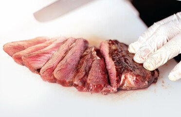 Ribeye steak on the bone sliced on cutting board