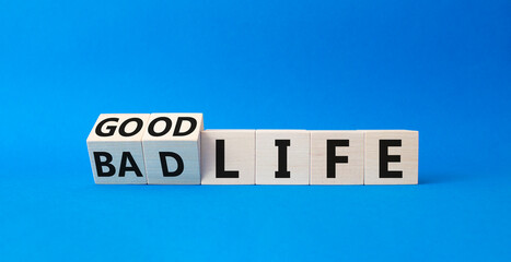 Good life and Bad life symbol. Turned cubes with words Good life and Bad life. Beautiful blue background. Business concept. Copy space