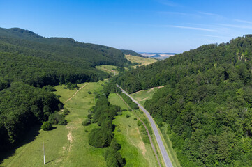 Fototapeta premium Landscape with a road through a rural area in Romania