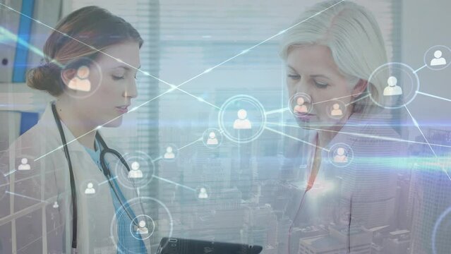 Animation of network of connections with icons and light trails over diverse doctor and patient