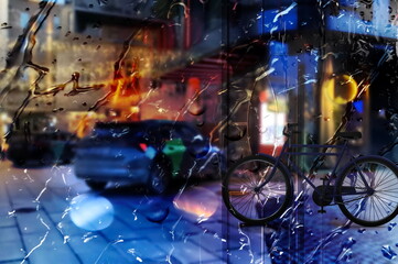 Rain  on window glass view on street bike and car traffic  night city blurred bokeh light