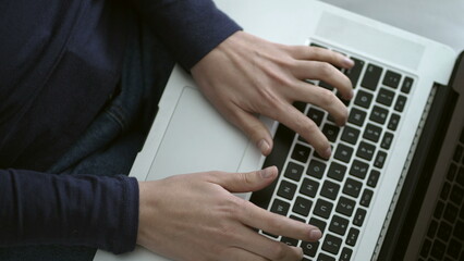 Fototapeta na wymiar Closeup female hands typing on laptop computer keyboard
