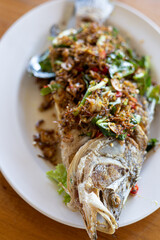 Fried Turmeric Fish in white plate