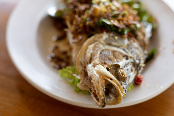 Fried Turmeric Fish in white plate