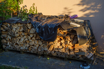stockpile of wood in sunset light for the coming cold winter, autonomous heating because of the gas...