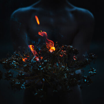 Autophobia, autism. Fear of loneliness. Phobia, fear, mania, cycle, artistic photo, surrealism. A thin man holds a burning branch in his hand