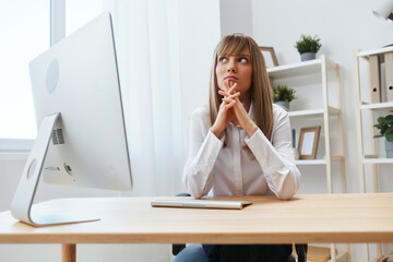 Pensive adorable blonde businesswoman look aside thinking of problem solution folded hands in light...