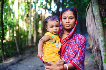 south asian young mother with her son, Bangladeshi hindu religious woman wearing traditional...
