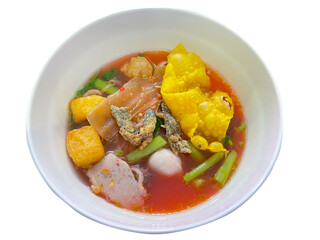 Thailand traditional red tofu sauce noodles served with fish ball, fried tofu and other. A popular delicious street food of Thai peoples. Asian food. Shot from above. Isolated on white background.