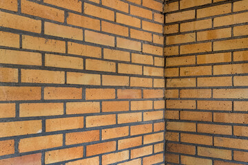 Corner of a yellow-red brick wall
