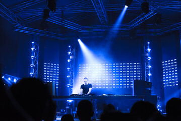 Dj playing techno music on the night concert in summer