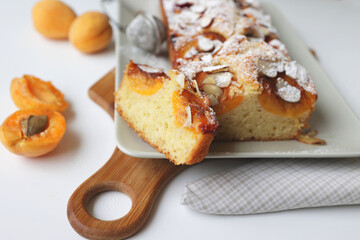 rectangular appetizing homemade apricot pie on a rectangular plate. Cut portion piece close-up