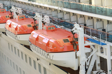 Lifeboats hanging over deck on cruise ship