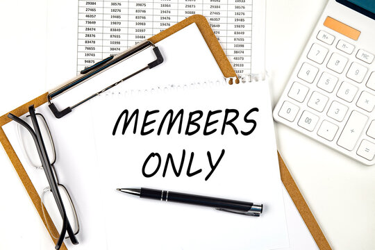Text MEMBERS ONLY on the white paper on clipboard with chart and calculator