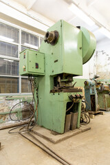 Old soviet hydraulic press in the production hall of an engineering plant